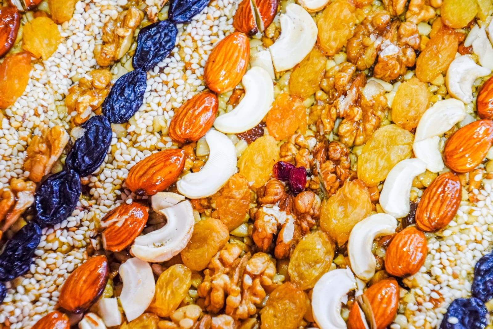 Kozinaki covered with nuts and seeds. Almonds, cashews and raisins.